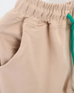 Sale Beżowe damskie spodnie dresowe z kolorową naszywką Spodnie Dresowe