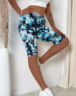 Outlet Ciemnoniebieskie damskie spodenki 3/4 z kwiatowym wzorem Spodenki 3/4|Krótkie Spodenki