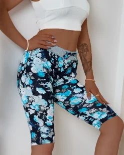 Outlet Ciemnoniebieskie damskie spodenki 3/4 z kwiatowym wzorem Spodenki 3/4|Krótkie Spodenki